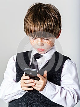 Emotional red-haired boy with mobile phone