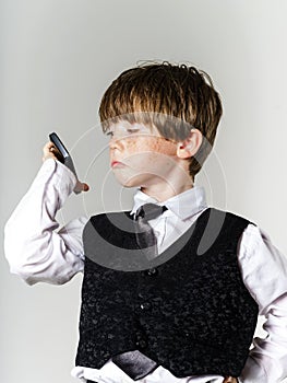 Emotional red-haired boy with mobile phone