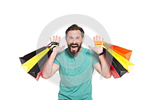 Emotional sales time. Men crazy about shopping. Extremely happy man with colored shopping bag in hands on white background. SALES! photo