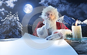 Emotional Santa Claus congratulating with New Year and Christmas, writing a letter, wish list in midnight with candle