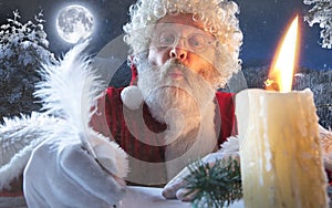 Emotional Santa Claus congratulating with New Year and Christmas, writing a letter, wish list in midnight with candle