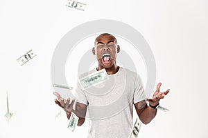 Emotional screaming young african man with money.