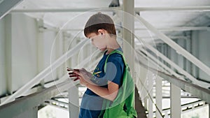 Emotional shots of the boy under the bridge. It stands on metal structures.