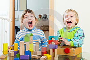 Emotional sibling playing in blocks in home