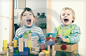 Emotional sibling playing in blocks in home