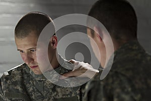 Emotional soldier talking with peer, horizontal