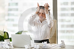 Emotional stressed businesswoman having nervous breakdown after photo