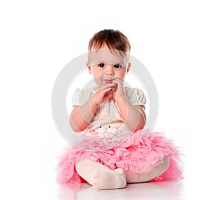 Emotional studio portrait of cute shy baby girl