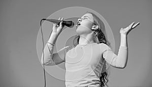 emotional teen girl singing karaoke in microphone