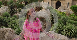 Emotional teen girl singing song gesturing clapping hands on resort vacation.