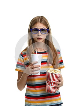 Emotional teenage girl with 3D glasses, popcorn and beverage during cinema show