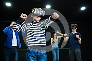 Emotional tween boy playing vr game with family
