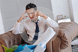 Emotional unemployed man going crazy while sitting at home