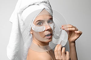 Emotional woman with cotton face and eye masks
