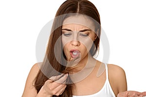 Emotional woman with damaged hair on white. Split ends