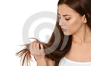 Emotional woman with damaged hair on white. Split ends