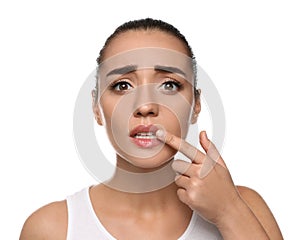 Emotional woman with herpes touching lips on white background