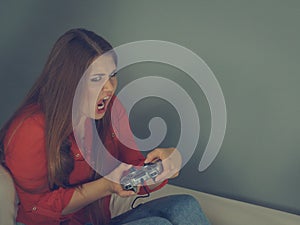 Emotional woman playing video games