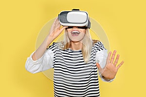 Emotional woman playing video games with virtual reality headset