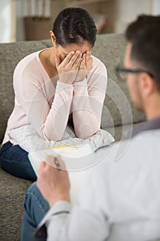 emotional woman talking to psycholoist