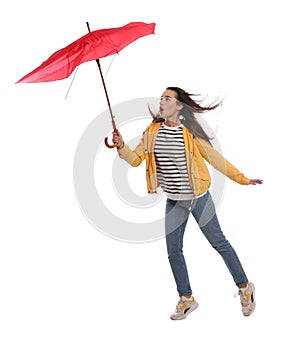 Emotional woman with umbrella caught in gust of wind on white background