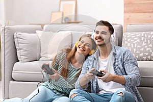 Emotional young couple playing video games