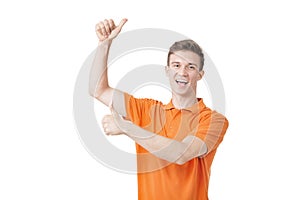 Emotional young man with brown hair screaming and raising hands in the air, feeling excited. Success concept