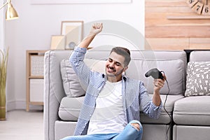 Emotional young man playing video games
