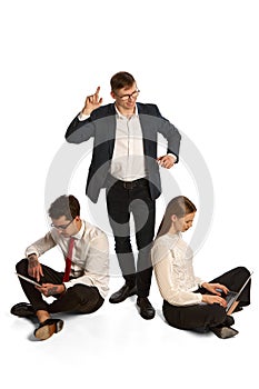 Emotional young people, businessmen, co-workers sitting and discuss new project, studying isolated over white background