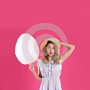 Emotional young woman with cotton candy