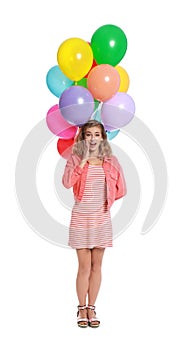 Emotional young woman holding bunch of colorful balloons on white