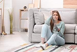 Emotional young woman playing video games