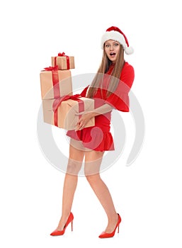 Emotional young woman in Santa hat with Christmas gifts on white