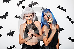 Emotional young women in halloween costumes