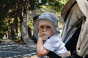 Emotionally dissatisfied indignant child in a stroller.