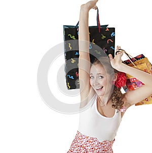 Emotionally happy young girl holding shopping gift bags.
