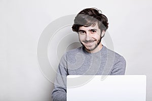 Emotions, human, modern technologies and lifestyle concept. Happy attractive young bearded guy enjoying free wireless connection,