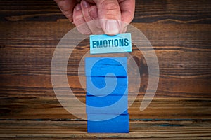 EMOTIONS. Psychology and mental health. Blue blocks in a pile on a wooden background