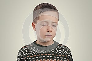 Emotions. Sad boy looking down.