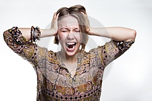Emotions is stress, madness. concept crazy shouting. woman rending her hair. natural teenager screaming with close eyes