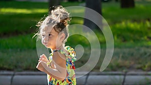 Emotions in the Sun, A Girl in the Playground dancing with his inflated cheeks