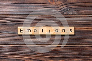 EMOTIONS word written on wood block. EMOTIONS text on cement table for your desing, concept