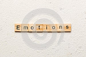 EMOTIONS word written on wood block. EMOTIONS text on cement table for your desing, concept
