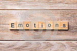 EMOTIONS word written on wood block. EMOTIONS text on wooden table for your desing, concept