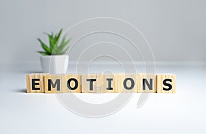 EMOTIONS word written on wood block, psychology concept