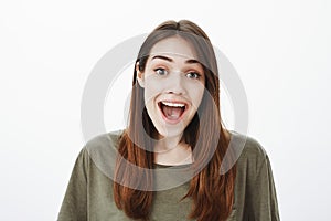 Emotive happy girl cheerfully talking with friends in cafe. Portrait of satisfied grinning european woman with pleased