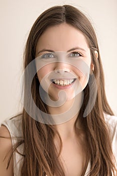 Emotive headshot portrait of happy young woman