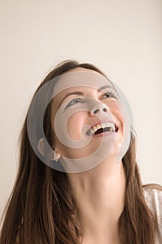 Emotive headshot portrait of joyful young woman