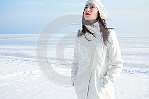 Emotive portrait of fashionable model in white coat and beret