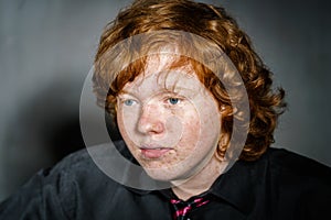 Emotive portrait of red-haired freckled boy, childhood concept